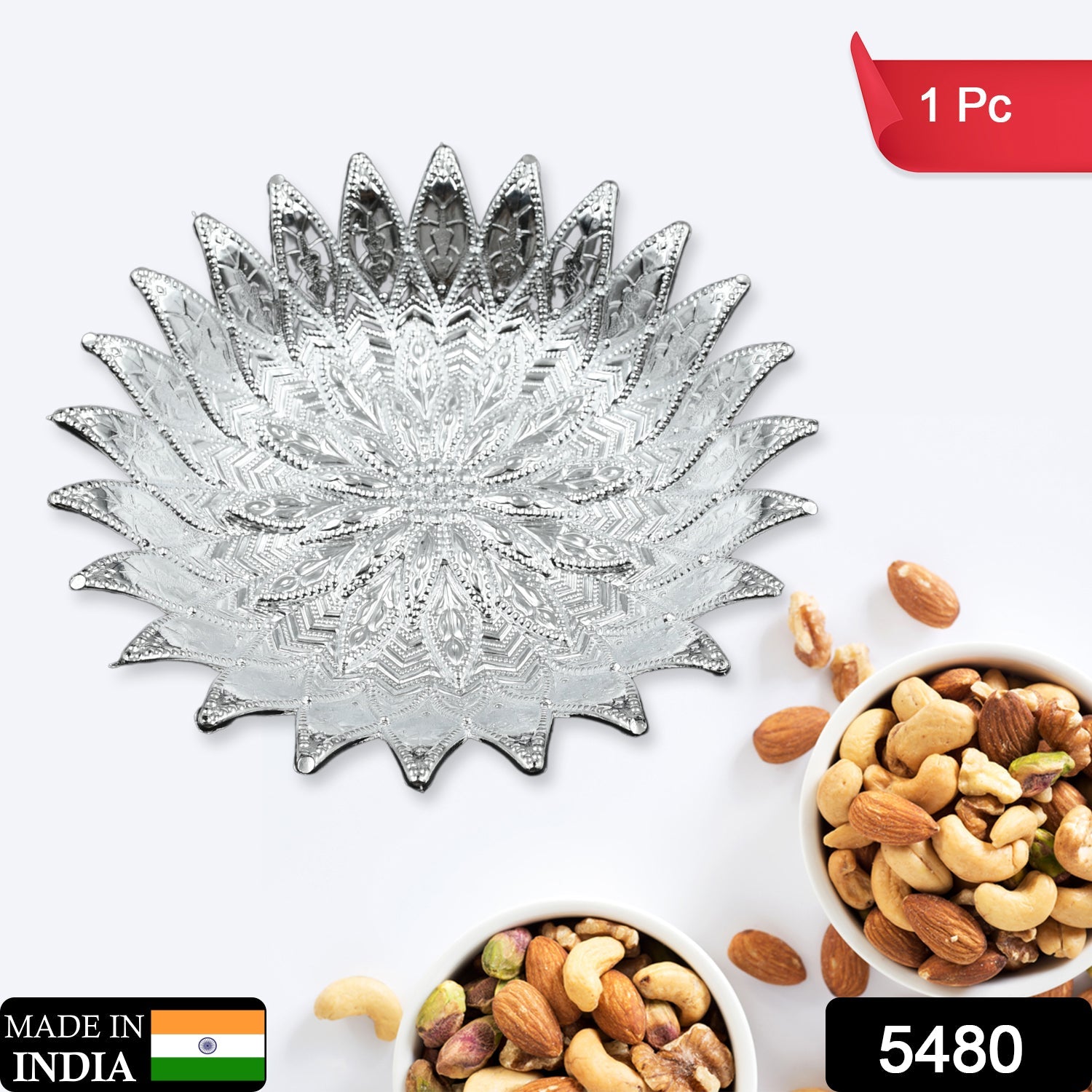 Close-up of a traditional silver finish plastic serving tray with intricate design.