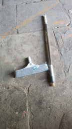 Plastic kitchen wiper used on a window pane, leaving a streak-free clean finish