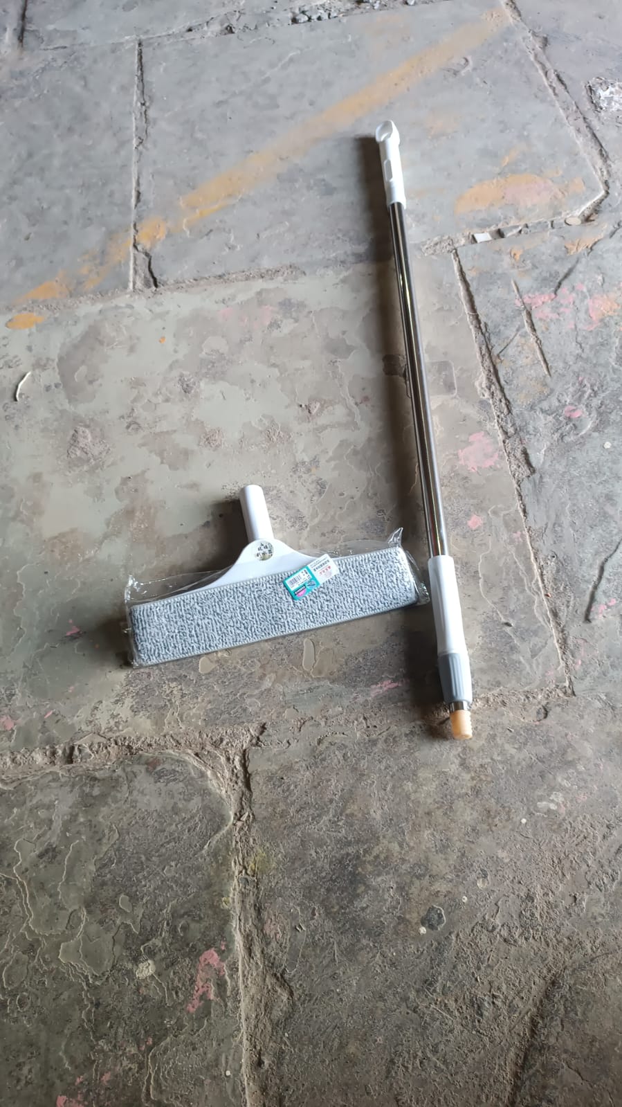 Plastic kitchen wiper used on a window pane, leaving a streak-free clean finish