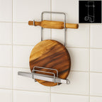 Stainless steel chakla belan chimta stand holding a rolling pin and tongs, showcasing kitchen organization.