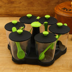 Miracle 6-piece revolving spice rack with transparent jars and spoons on a white background.