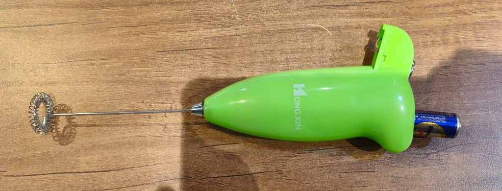 Detailed view of the XcelCraft hand blender's robust stainless steel blending shaft.