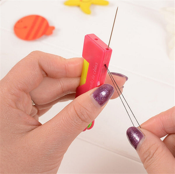Multicolour automatic needle threading device showing a needle and thread ready for use.