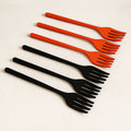 A set of six vibrant silicone cooking forks in various colors, neatly arranged.
