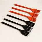 A set of six vibrant silicone cooking forks in various colors, neatly arranged.