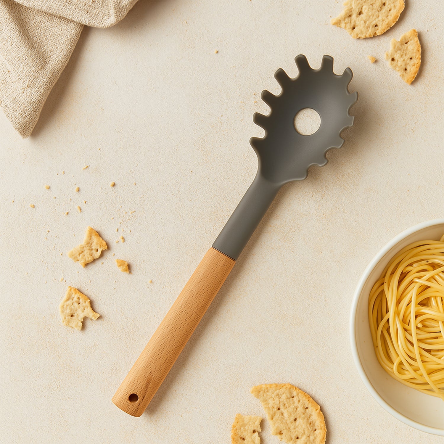 Durable plastic pasta fork in grey, ideal for serving noodles.