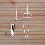The AuriGlam mini nail clipper set shown with its protective plastic storage case.