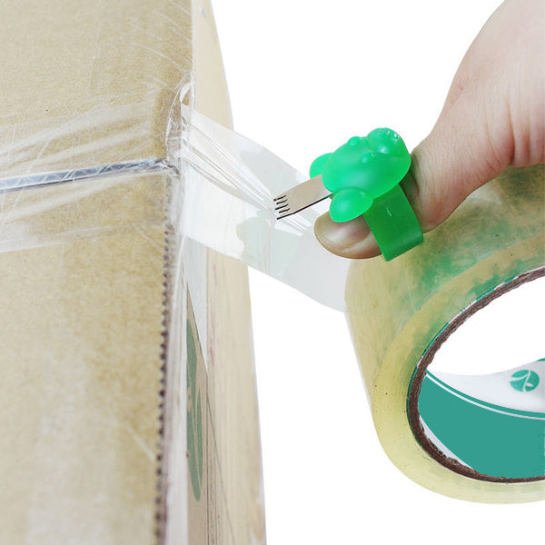 A person effortlessly cuts packing tape using the compact Finger Tape Cutter.