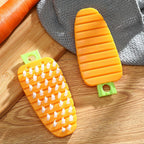 Hand holding the carrot-shaped vegetable brush over fresh produce.