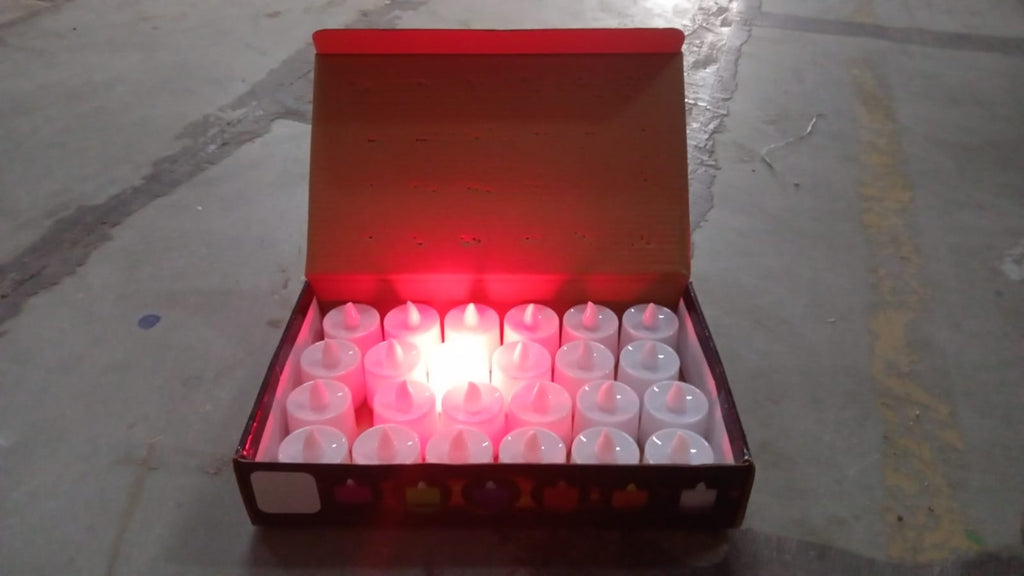 Red LED flameless tealight candles glowing softly on a decorative surface