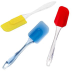 Assorted heat-resistant silicone baking tools on a kitchen counter.