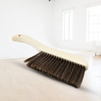 Versatile brush for removing small particles, lint, and pet hair from various fabric surfaces.