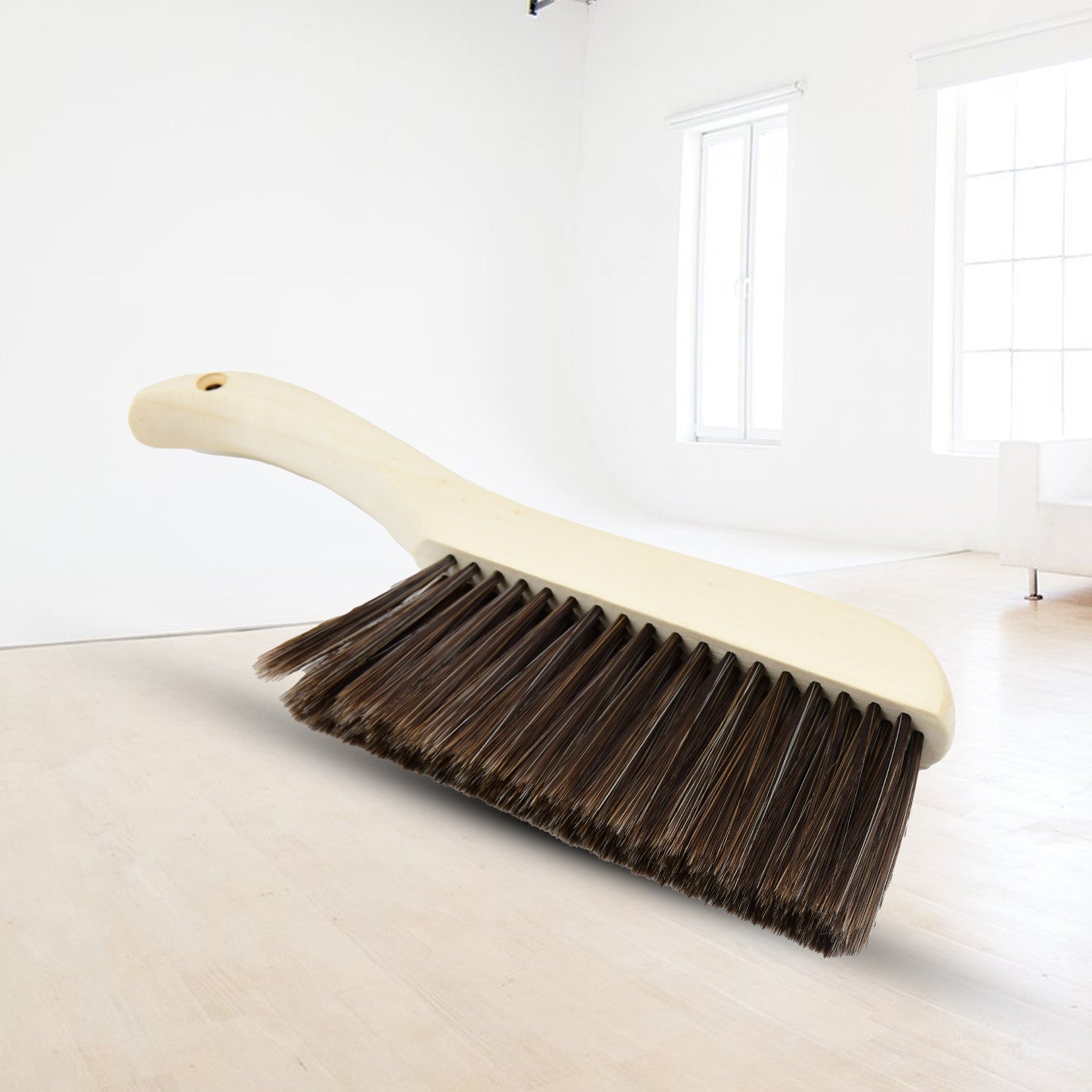Versatile brush for removing small particles, lint, and pet hair from various fabric surfaces.