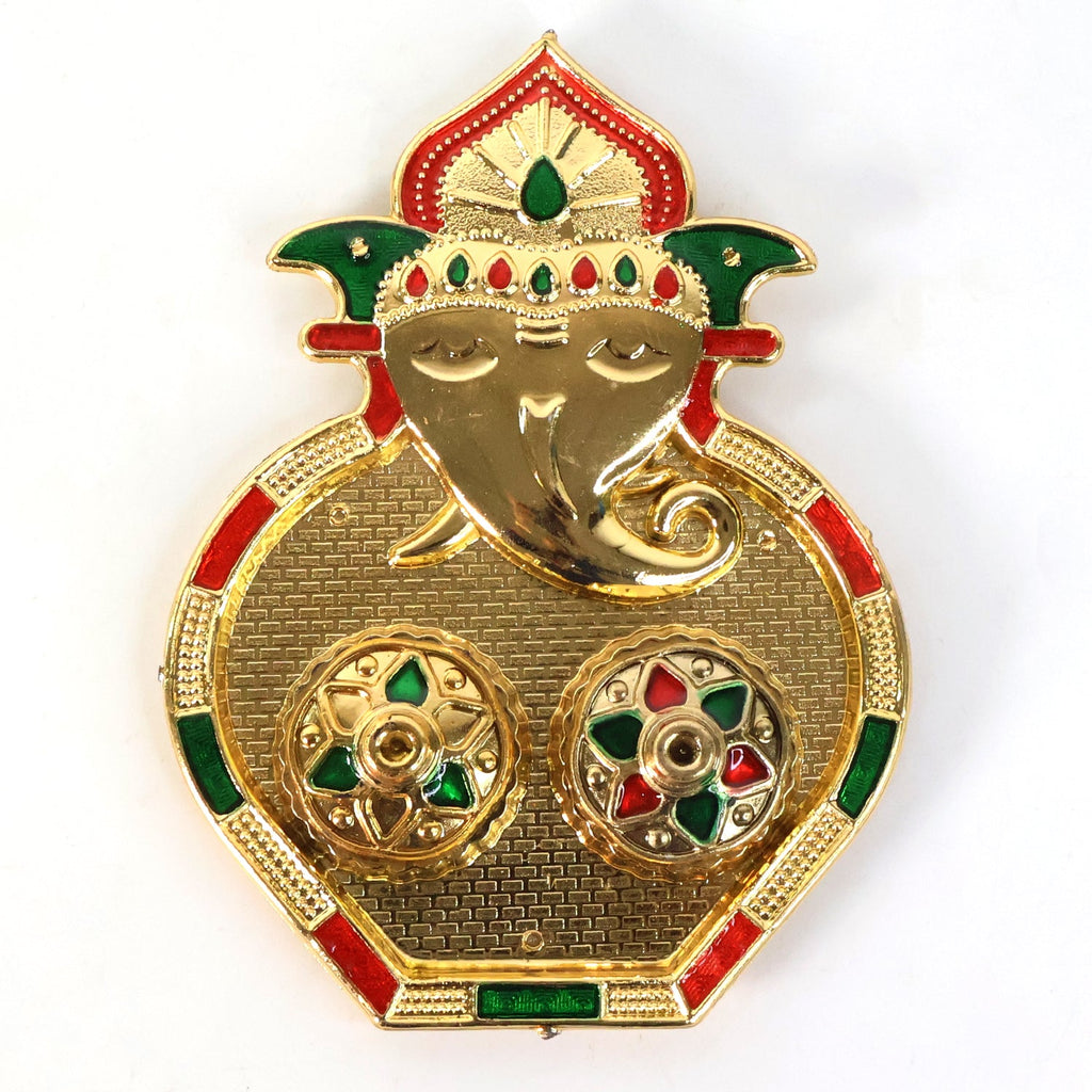 Close-up of golden kumkum container embellished with multicolor stones