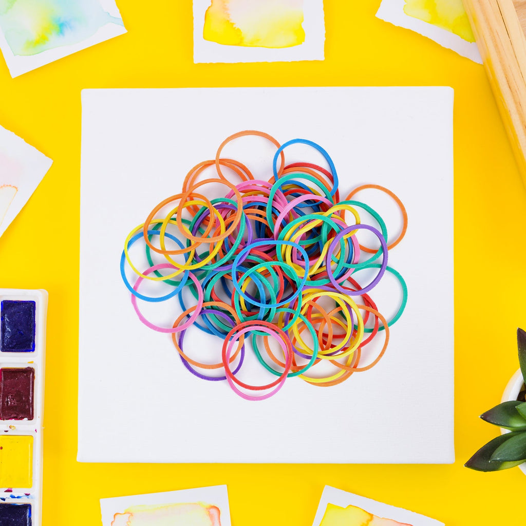 Close-up view of a stretched multicolour rubber band demonstrating its elasticity.