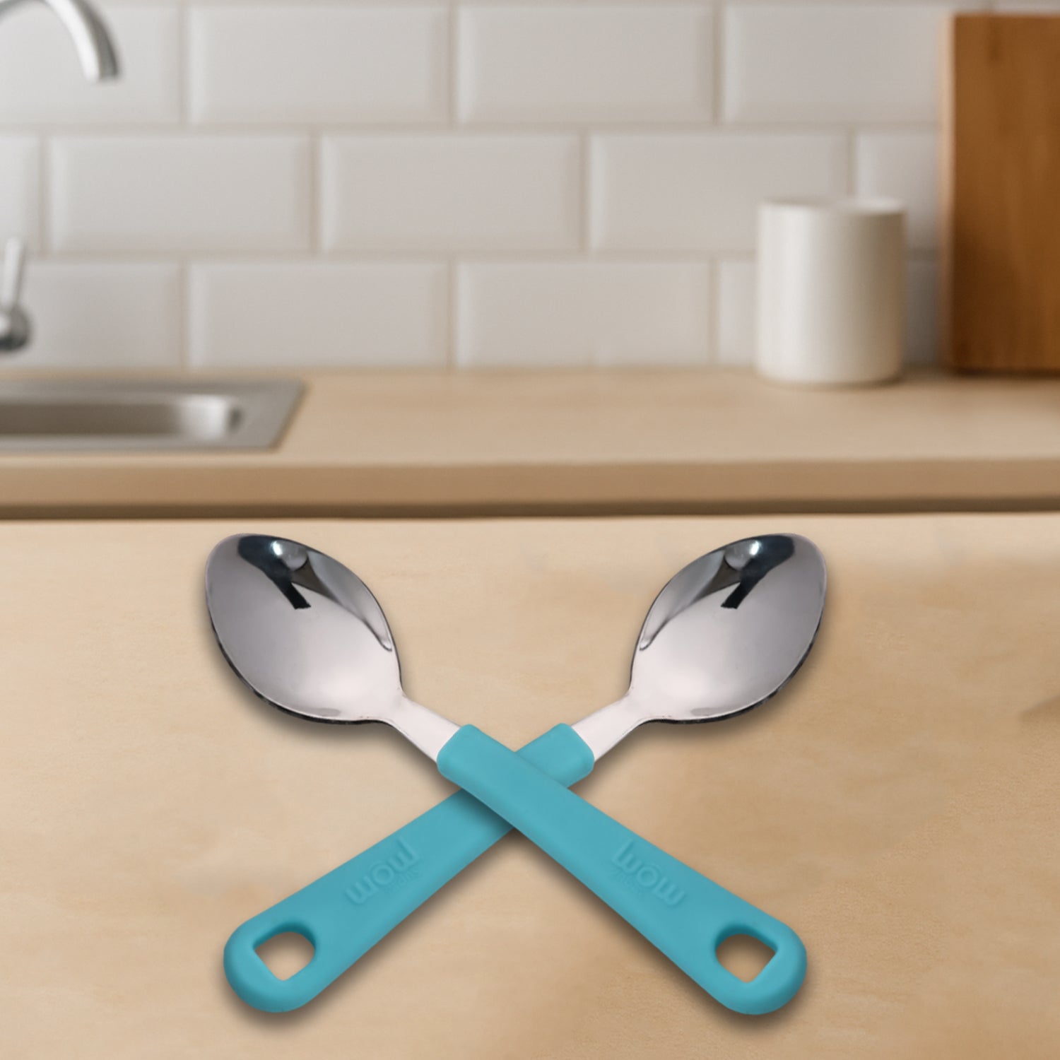 Side view of stainless steel tea spoon with firm plastic handle