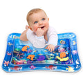 A baby happily playing on an inflatable Baby Water Mat with colourful floating ocean creatures.