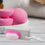XcelCraft pumice stone foot scrubber with dual-action brush for smooth feet.
