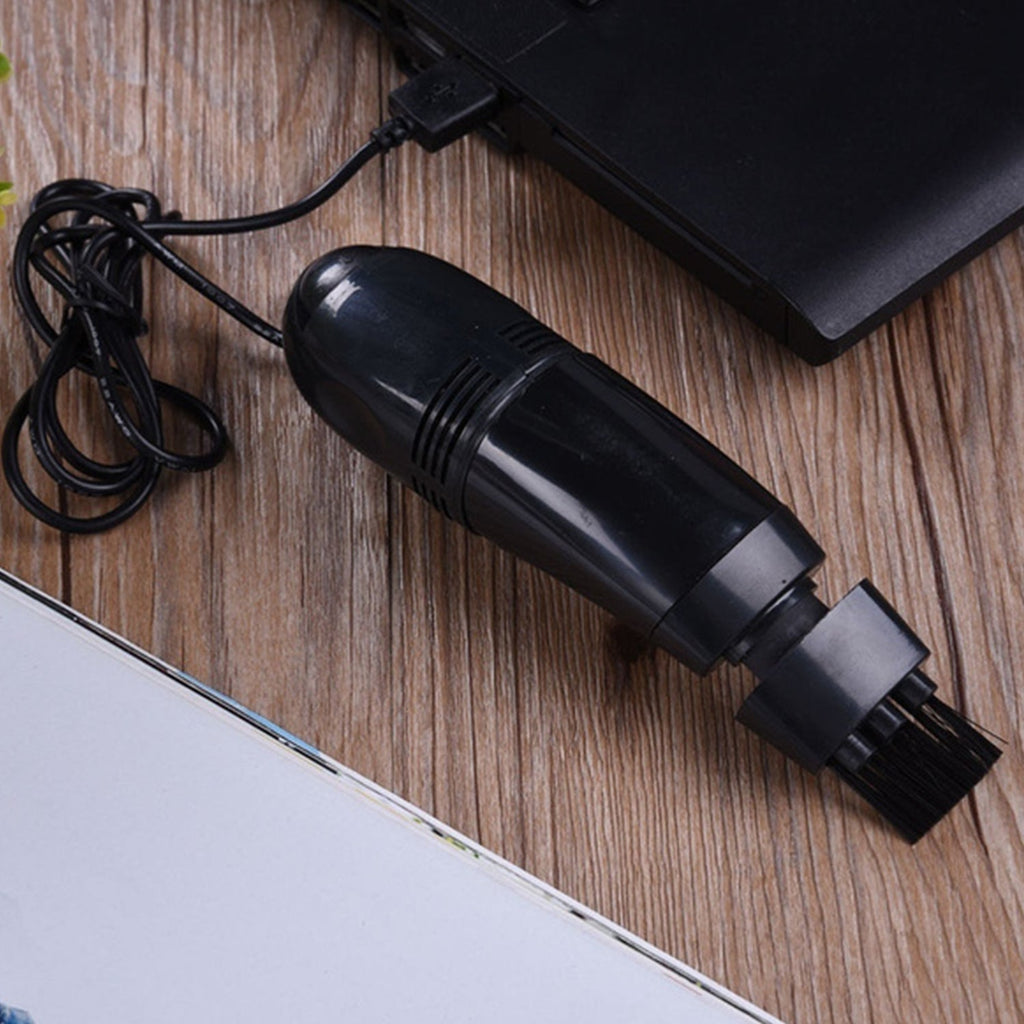 USB mini vacuum cleaner effectively cleaning car interior crevices.