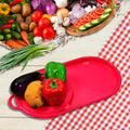 Plastic chopping board with integrated tray, shown with chopped vegetables.