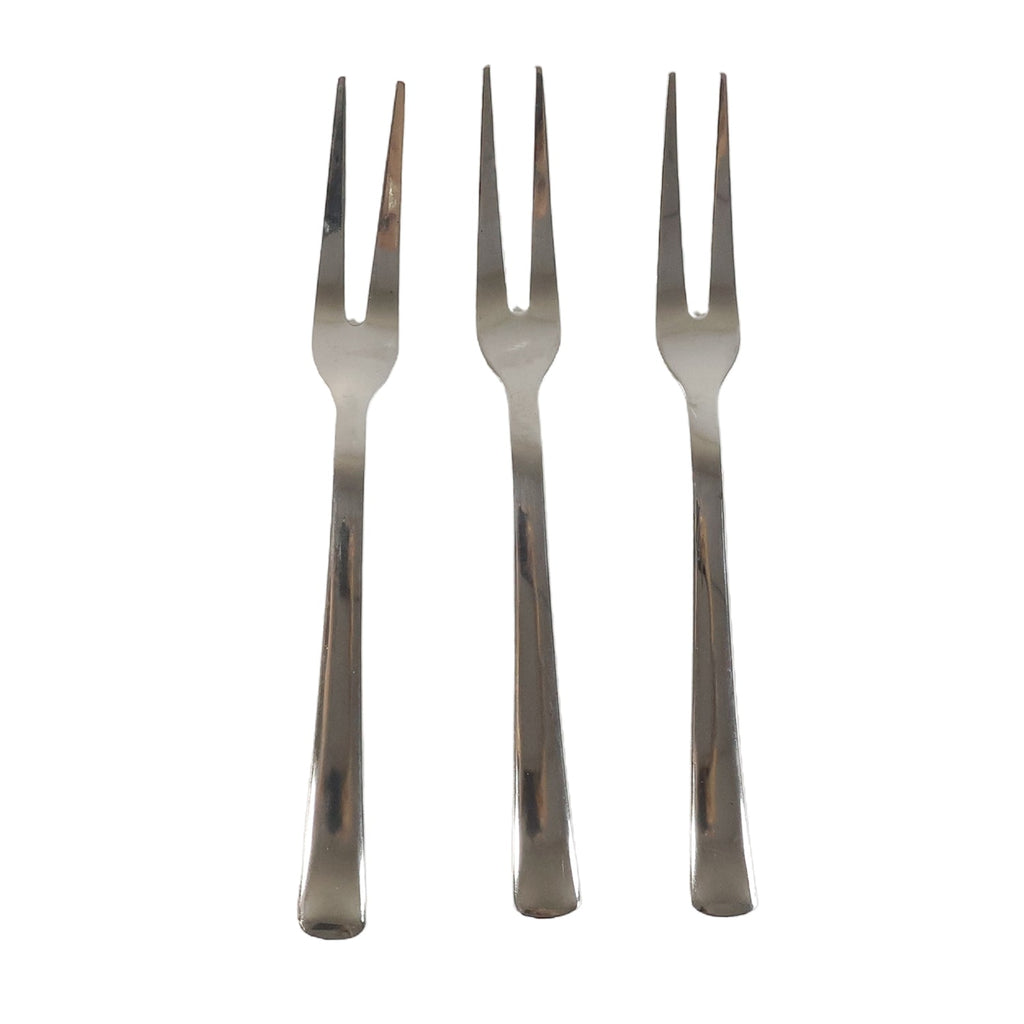 Three small appetizer forks laid out for serving snacks
