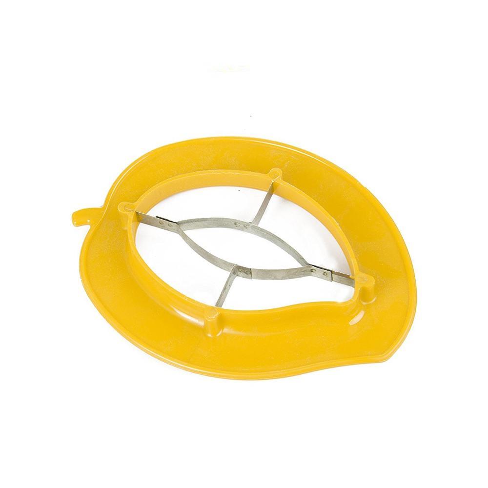 An overhead shot of the mango cutter next to a whole mango and a bowl of sliced mangoes.