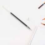 Detailed view of the tip and ink chamber of a black pen refill.