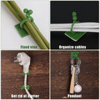 Multiple wall plant clips used to organize cables and wires on a desk.