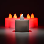 Red flameless tealight candles placed in decorative holders creating ambient lighting