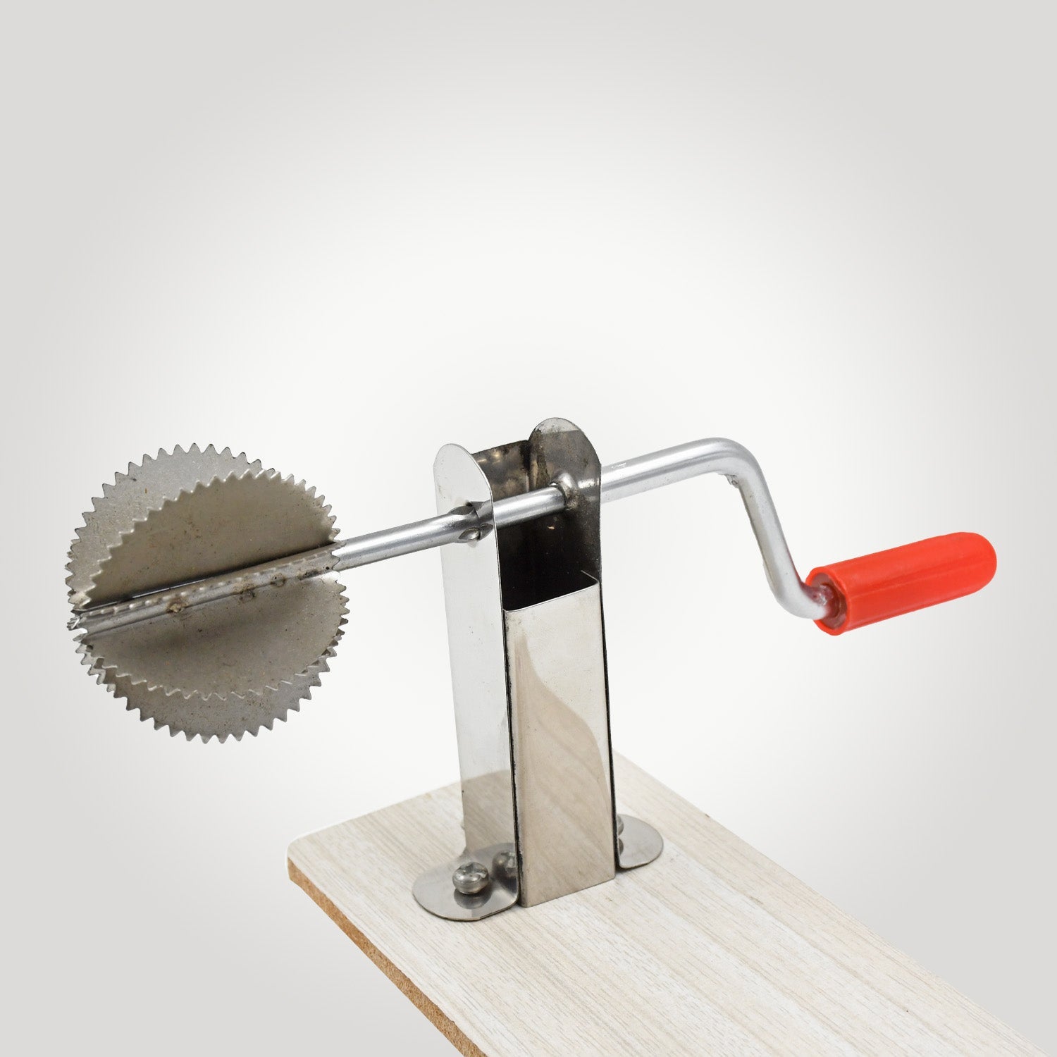 Close-up view of the Quickslice stainless steel coconut scraper's grating surface.