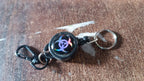 Retractable key chain attached to a belt, ideal for travel and office use.