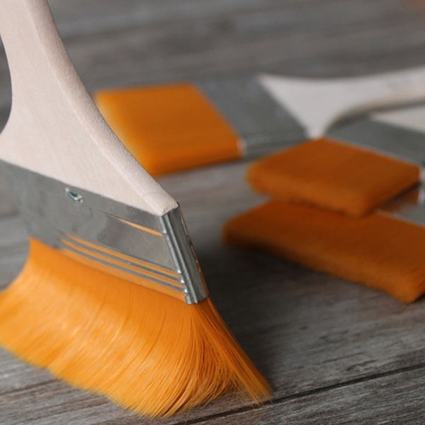 Detail of a high-grade aluminum ferrule securely holding the synthetic bristles of a flat paint brush.
