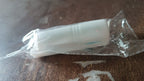 Lifestyle image of a hand holding the lint roller over clothing.