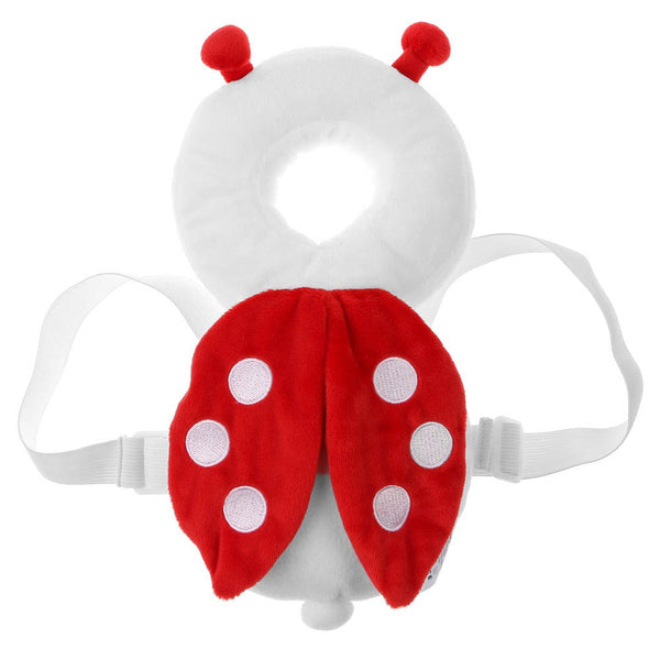 A baby wearing the bee Baby Head Protector, comfortably seated on a sofa at home.