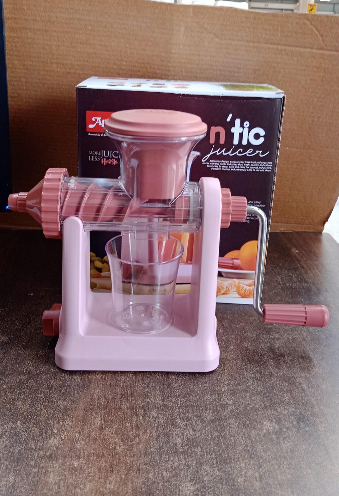 Side view of manual juicer with ergonomic handle and vacuum base