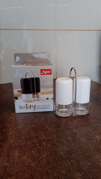 Salt and pepper seasoning dispensers placed neatly on kitchen counter