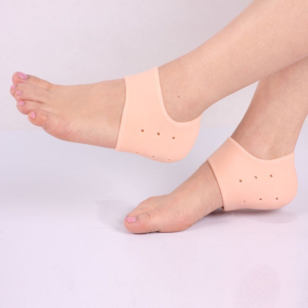 A pair of transparent silicone heel protectors for cracked heels.