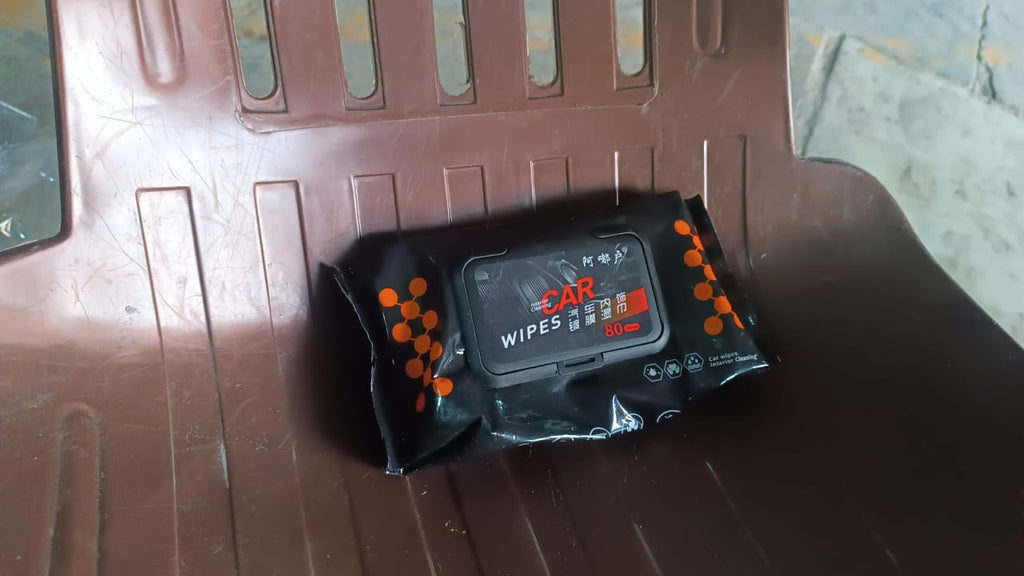 Open pack of Car Cleaning Wipes next to a clean car dashboard