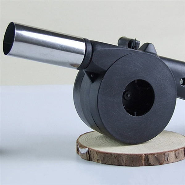 Compact and lightweight hand crank BBQ air blower fan from an angled perspective.