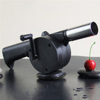 Portable hand crank BBQ air blower fan in black and silver.