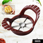 A whole red apple positioned below the stainless steel fruit slicer, ready for cutting.
