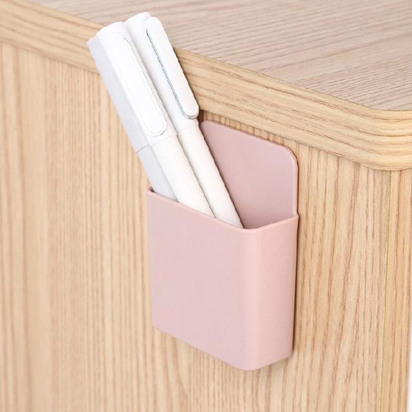 Pack of four wall mounted phone holders shown in their retail packaging.