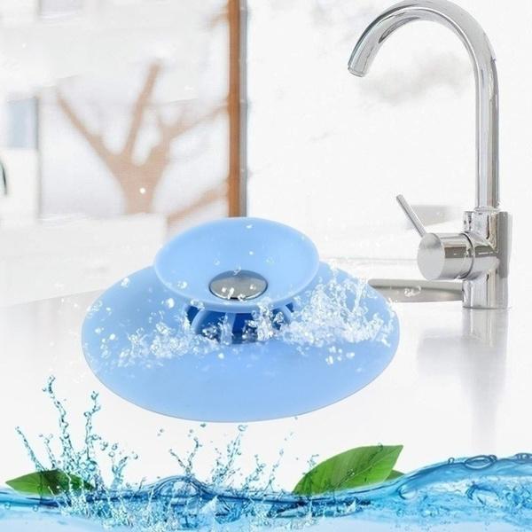 Multicolor silicone sink drainer cover securely fitting a sink drain