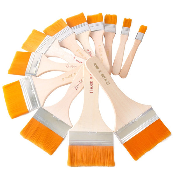 Close-up of a flat paint brush highlighting the connection between its curved handle and synthetic bristles.