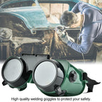 Worker wearing comfortable dark green welding goggles over eyeglasses for industrial use.