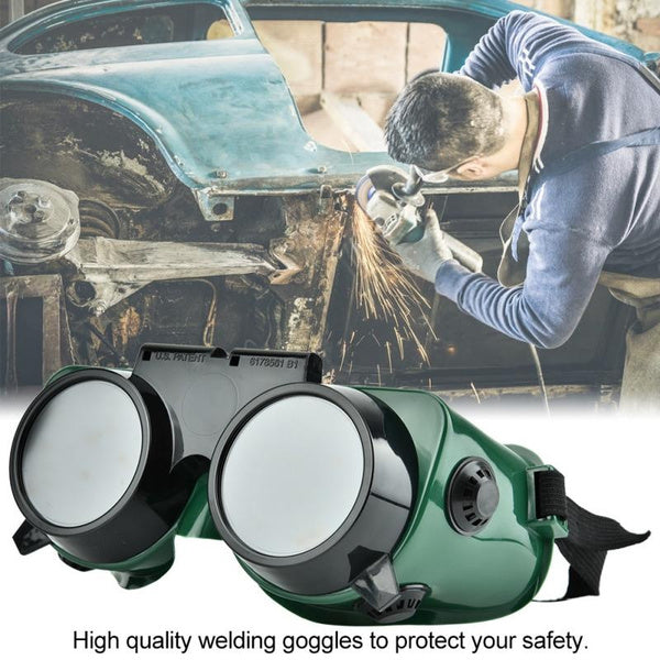 Worker wearing comfortable dark green welding goggles over eyeglasses for industrial use.