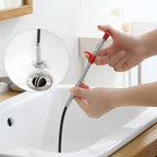 Detailed view of the drain cleaner tool's claw mechanism for grabbing stubborn clogs.