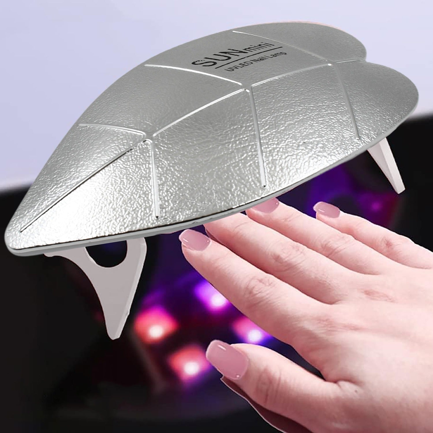 Compact 6W Mini UV LED nail lamp on a clean white surface for gel polish curing.