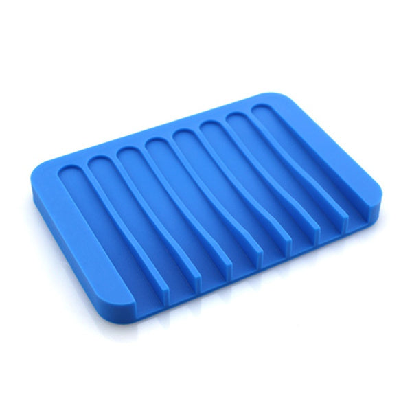 Top-down view of a white silicone soap holder with drainage slots.