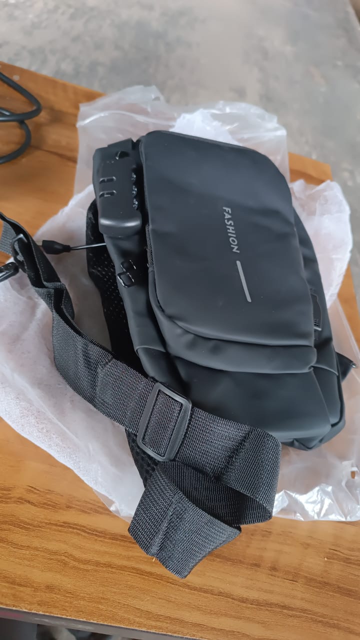 Anti-theft sling bag displayed hanging, featuring secure lock and water-resistant fabric